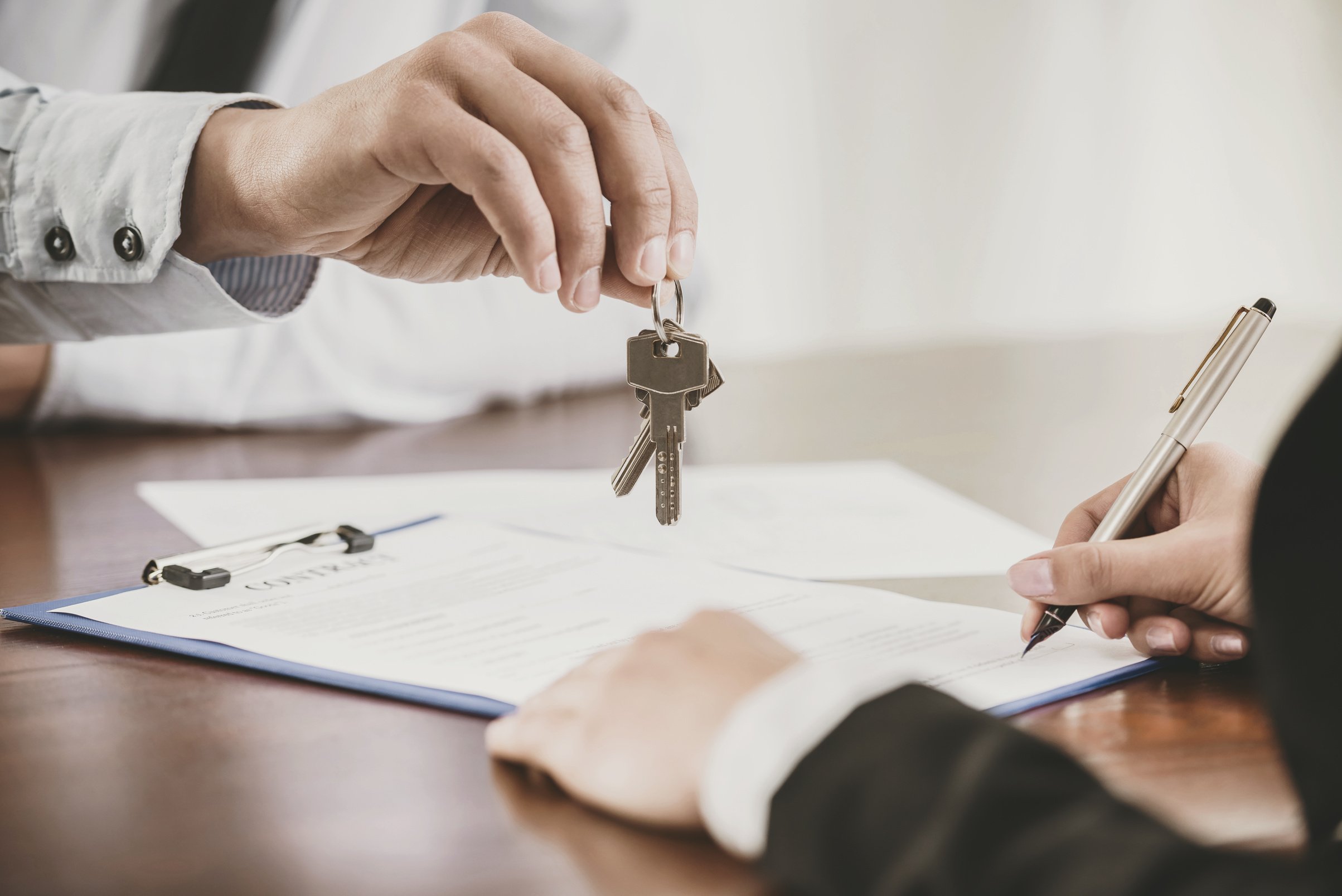 Close up. Tenant Signs Contract with Real Estate Agent.